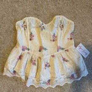 Strapless floral print top with lace detailing.